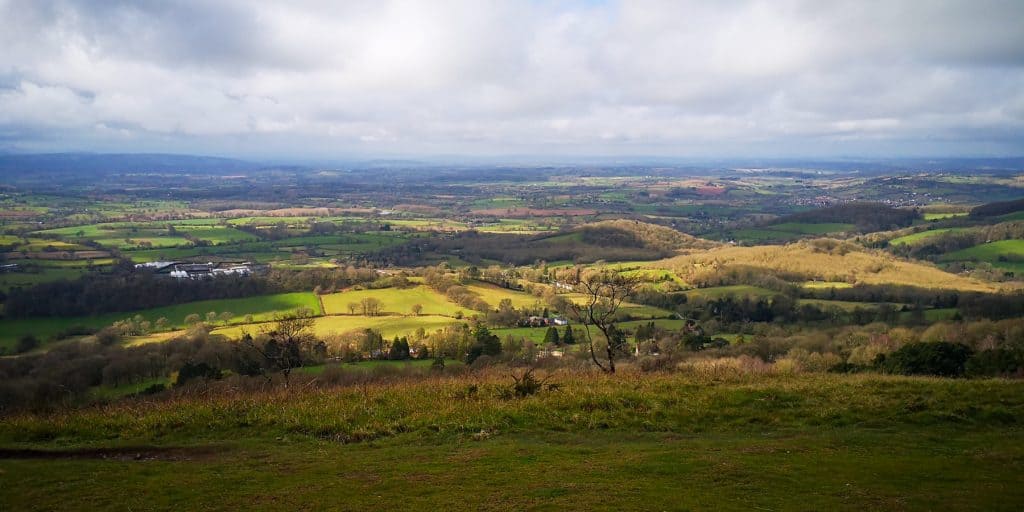 A trail at the top of the hills with views of woodlands.