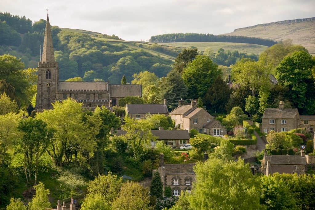 View at a village with stone cottages and a church.
