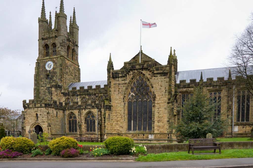 Old stone church with the flag of England.