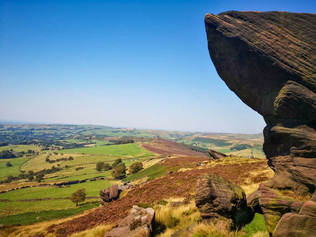 Rock formation with meadows and hills; the Roaches is among the best Peak District walks.
