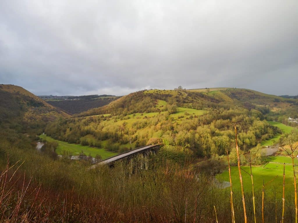 View at a valley with bridge and hills.