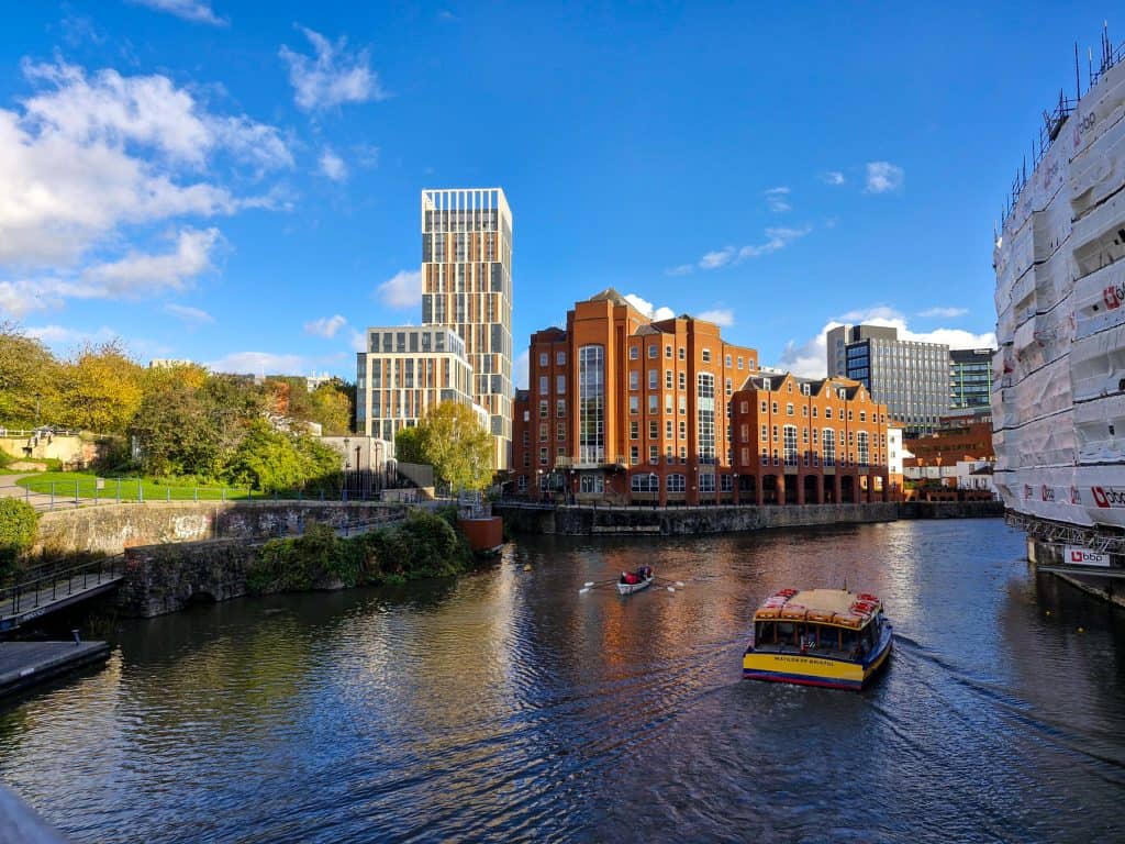 Views at the riverfront with a small ferry and boat in Bristol.