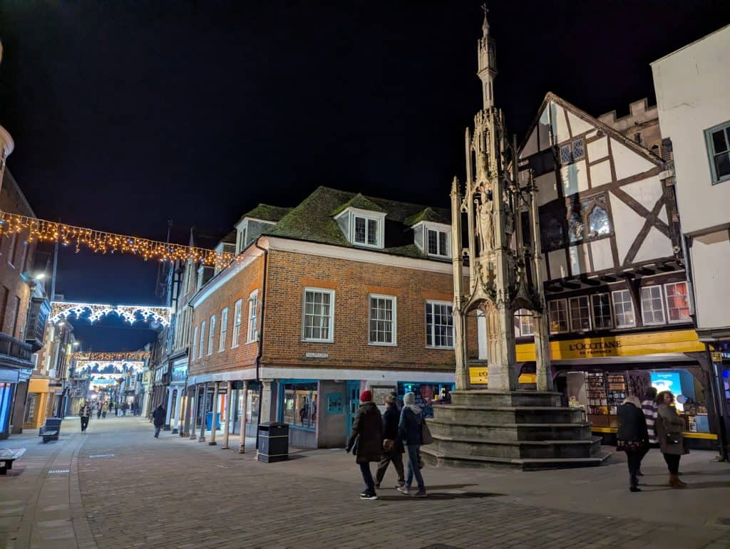 Winchester street with a historical monument at night.