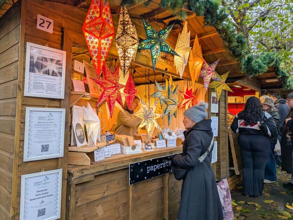 Christmas market in York - a stall with Christmas decoration and people.