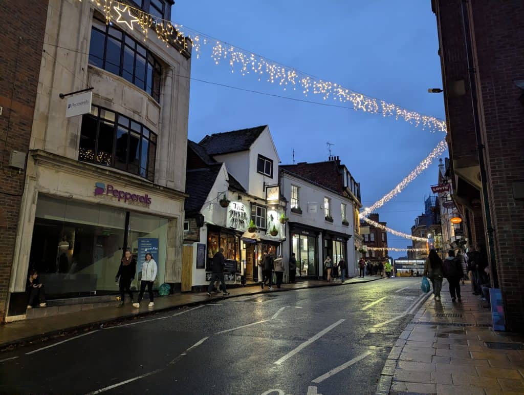 A street with Christmas lights at dusk in York.