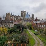 York Cathedral with buildings and gardens on a rainy day.