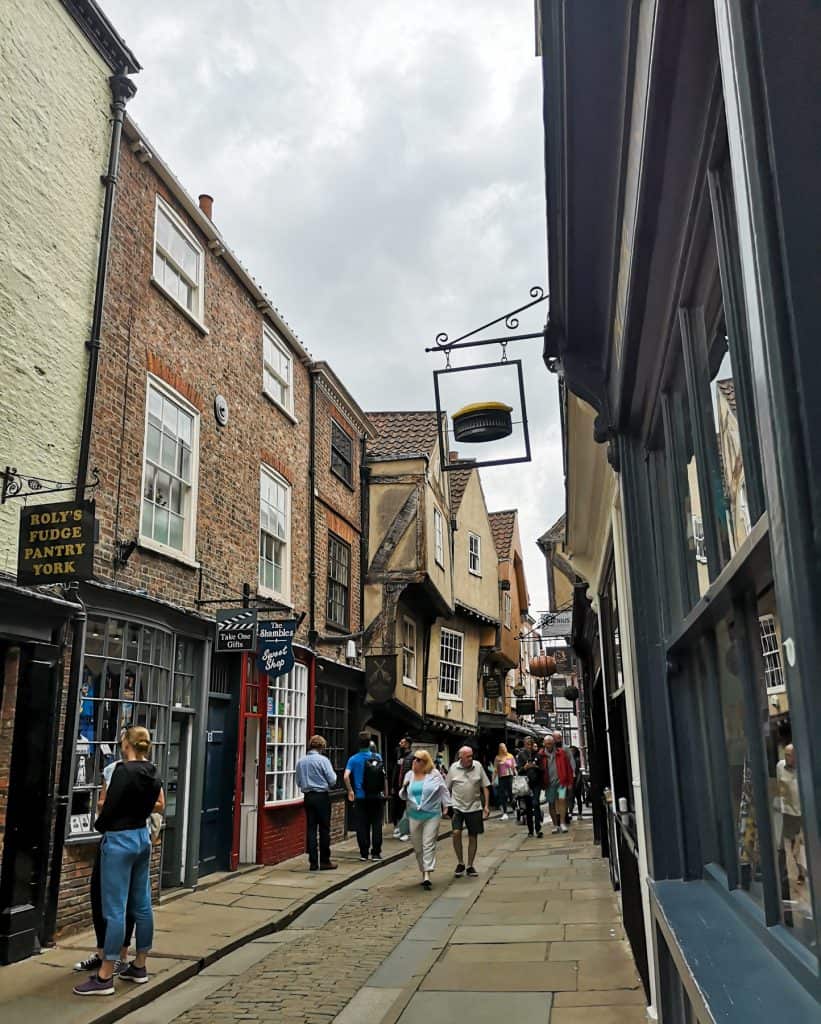 Shambles street in York with people in summer, one of the best things to do in York for couples.