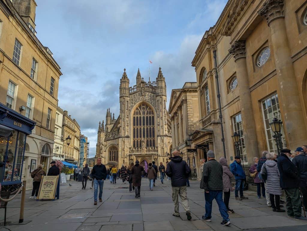 A view at the architecture in Bath - detail on Bath Abbey with people. Bath is one of the best places to go in UK in February.