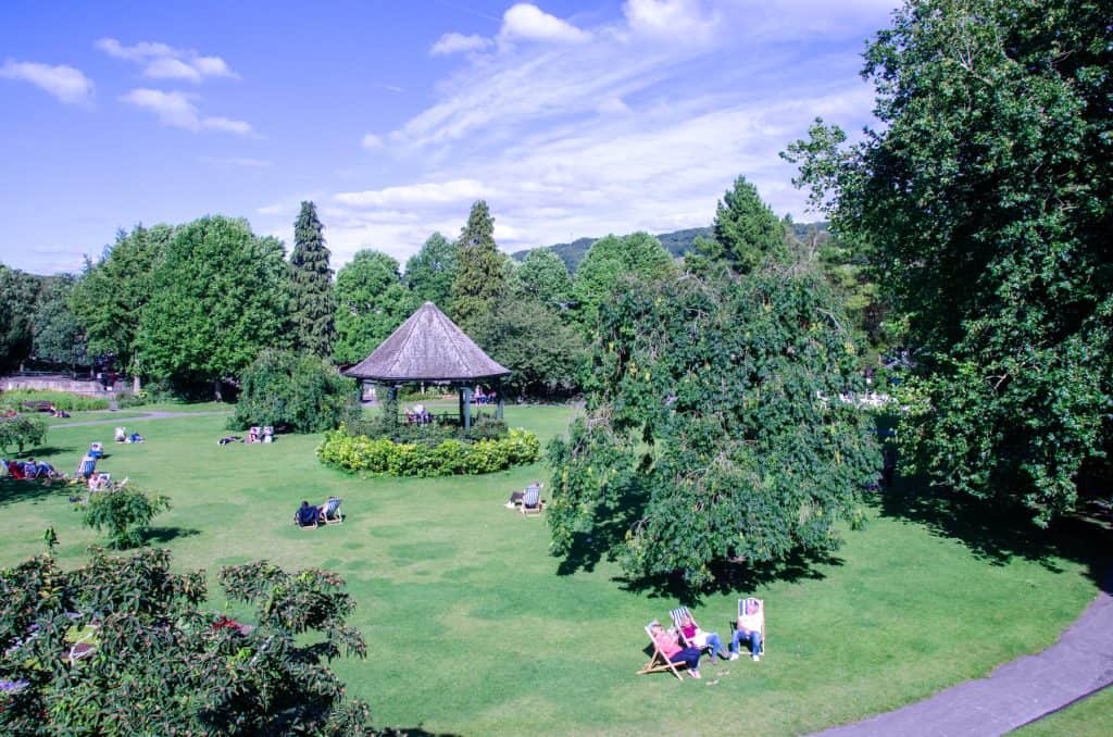 A park in Bath with people chilling and enjoying summer weather.