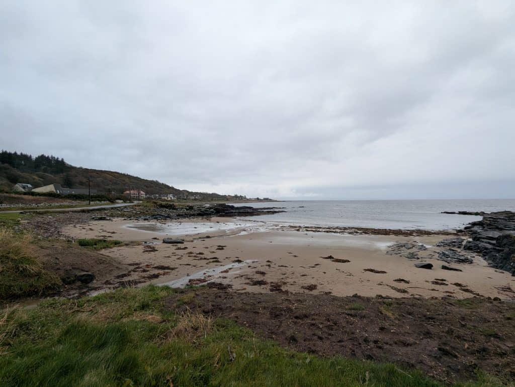 Beach near Kildonan on a cloudy day with cottages.