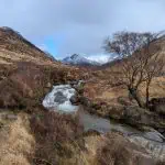 Glen Rosa, one of the most beautiful places on Isle of Arran, with the river, trees and snowy mountains. Exploring Glen Rosa is one of the best things to do on Isle of Arran.