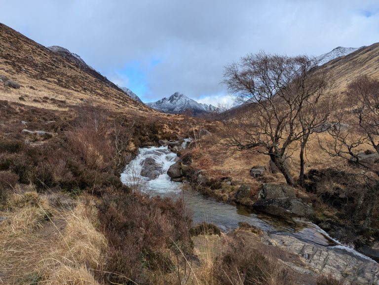 Glen Rosa, one of the most beautiful places on Isle of Arran, with the river, trees and snowy mountains. Exploring Glen Rosa is one of the best things to do on Isle of Arran.