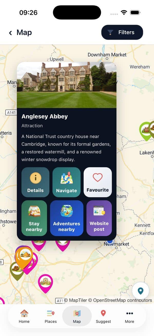 A place card open on the map for Anglesey Abbey, showing the Navigate button alongside Details, Favourite, Stay nearby, Adventures nearby and Website post.